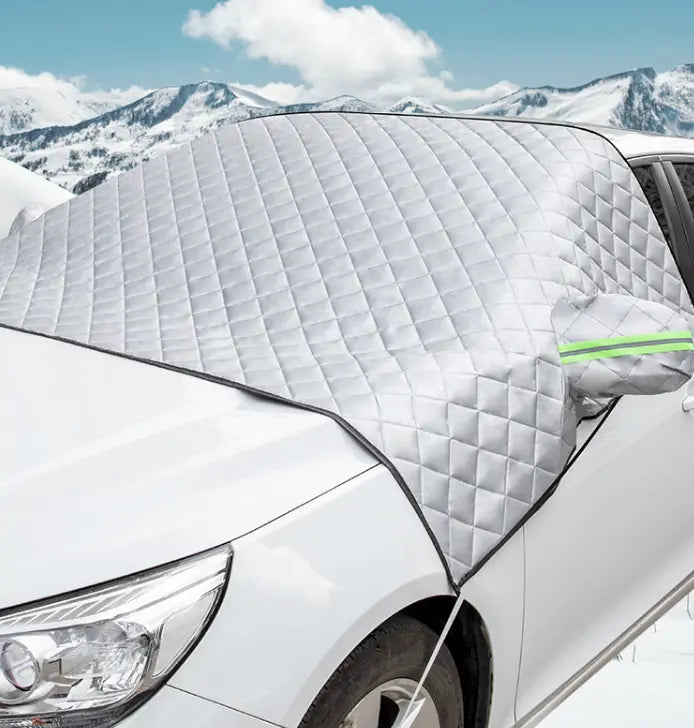 Silver windshield snow and frost protector installed on a car